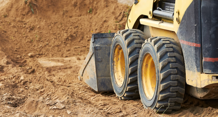 Bobcat dozer pushing dirt in excavation