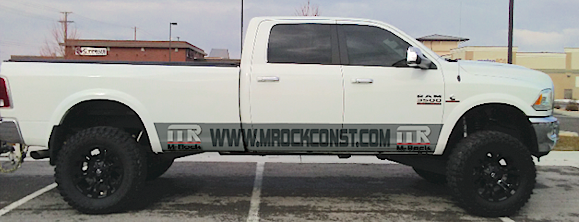 side view of white Dodge RAM 3500 pickup truck with prominent www.mrockconst.com decal