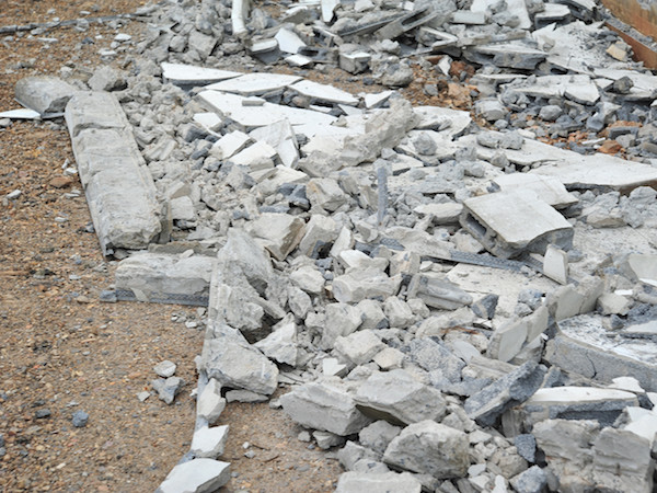 concrete and cement block demolished and laying on ground in small pieces