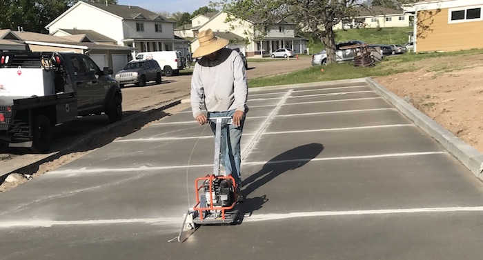 worker making concrete expansion cuts