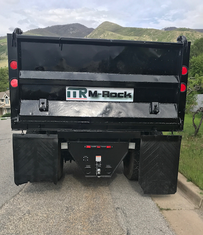tailgate of hauling truck with M-Rock logo